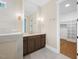 Bright bathroom with stylish lighting, vanity, and an open closet space at 2410 Carpenter Pond Rd, Raleigh, NC 27613