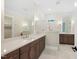 Elegant bathroom with marble floors, dual vanities, and gold fixtures at 2410 Carpenter Pond Rd, Raleigh, NC 27613