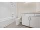 Bathroom featuring a shower and tub combination with white tile surround, plus a vanity sink with gray countertop at 2410 Carpenter Pond Rd, Raleigh, NC 27613
