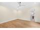Bright bedroom with hardwood floors, neutral walls, and a ceiling fan at 2410 Carpenter Pond Rd, Raleigh, NC 27613