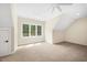Bright bedroom featuring a ceiling fan and a large window with a view of the trees at 2410 Carpenter Pond Rd, Raleigh, NC 27613