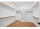 Spacious walk-in closet with built-in shelving and wood flooring at 2410 Carpenter Pond Rd, Raleigh, NC 27613