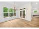 Elegant dining area featuring large windows, shiplap accent wall, and a stylish chandelier at 2410 Carpenter Pond Rd, Raleigh, NC 27613