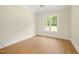 Neutral room featuring hardwood floors, white trim, and a ceiling fan at 2410 Carpenter Pond Rd, Raleigh, NC 27613