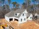 Exterior view of the house under construction featuring a two-car garage at 2410 Carpenter Pond Rd, Raleigh, NC 27613