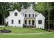 Charming two-story home with a landscaped yard and painted brick at 2410 Carpenter Pond Rd, Raleigh, NC 27613