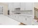 Modern kitchen featuring white cabinets, stainless steel appliances, and a stylish backsplash at 2410 Carpenter Pond Rd, Raleigh, NC 27613