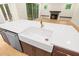 Modern kitchen features a white farmhouse sink, stainless steel dishwasher, and wooden cabinets at 2410 Carpenter Pond Rd, Raleigh, NC 27613