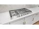Professional grade Frigidaire gas cooktop on white countertops and white cabinets with bronze hardware at 2410 Carpenter Pond Rd, Raleigh, NC 27613