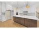 Bright kitchen with large center island, stainless appliances, and white cabinetry at 2410 Carpenter Pond Rd, Raleigh, NC 27613