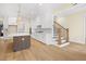 Beautiful kitchen with a large island, stainless steel appliances, and staircase access at 2410 Carpenter Pond Rd, Raleigh, NC 27613