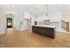Stunning kitchen with a large island, white cabinets, and stainless steel appliances at 2410 Carpenter Pond Rd, Raleigh, NC 27613