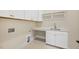 Functional laundry room with ample counter space, sink, and white cabinets at 2410 Carpenter Pond Rd, Raleigh, NC 27613