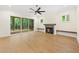 Bright living room with sliding doors to a screened porch, fireplace, and hardwood floors at 2410 Carpenter Pond Rd, Raleigh, NC 27613