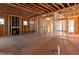 Unfinished living room with fireplace rough in and natural light at 2410 Carpenter Pond Rd, Raleigh, NC 27613