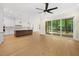 Open floor plan with a modern kitchen, living room with a ceiling fan and a screened porch at 2410 Carpenter Pond Rd, Raleigh, NC 27613