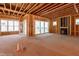 Unfinished living room featuring lots of windows and fireplace rough in at 2410 Carpenter Pond Rd, Raleigh, NC 27613