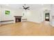 Comfortable living room featuring a fireplace, light hardwood floors and abundant natural light at 2410 Carpenter Pond Rd, Raleigh, NC 27613