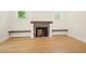 Cozy living room with a brick fireplace, built-in shelving, and bright windows at 2410 Carpenter Pond Rd, Raleigh, NC 27613