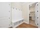 Mudroom with a bench and hooks for storage, leading to laundry at 2410 Carpenter Pond Rd, Raleigh, NC 27613
