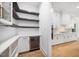 Bright pantry features open shelving, a beverage cooler, and leads into the kitchen at 2410 Carpenter Pond Rd, Raleigh, NC 27613