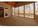 Spacious screened porch with wood flooring and view of wooded backyard at 2410 Carpenter Pond Rd, Raleigh, NC 27613