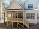 View of the wooden porch with railings and staircase leading down to the yard at 2410 Carpenter Pond Rd, Raleigh, NC 27613