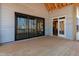 View of the covered porch with wooden flooring and large sliding doors leading inside at 2410 Carpenter Pond Rd, Raleigh, NC 27613