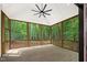 Spacious screened-in porch with wooden flooring and panoramic views of the surrounding nature at 2410 Carpenter Pond Rd, Raleigh, NC 27613