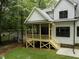 A charming screened-in back porch is visible in the yard at 2410 Carpenter Pond Rd, Raleigh, NC 27613