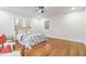 Bright bedroom with hardwood floors, a ceiling fan, and natural light from large windows at 2515 W Club Blvd, Durham, NC 27705