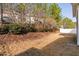 Backyard with a view of the house and fence line at 2518 Magnolia Tree Ln, Durham, NC 27703