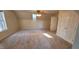 Large bedroom with a window that provides natural light, a ceiling fan, and carpet at 266 Sagamore Dr, Louisburg, NC 27549