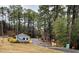 Community entrance featuring guard house, signage, and lush landscaping at 266 Sagamore Dr, Louisburg, NC 27549