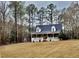 Charming brick home boasts a welcoming front porch and a well-maintained yard surrounded by mature trees at 266 Sagamore Dr, Louisburg, NC 27549