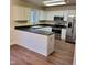 Kitchen features white cabinets, black countertops, and stainless steel appliances at 266 Sagamore Dr, Louisburg, NC 27549