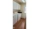 Laundry area featuring a washer, dryer, cabinets, countertop, and vinyl floors at 266 Sagamore Dr, Louisburg, NC 27549