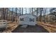 Exterior shot of backyard shed with white siding and door, accented by black shutters at 266 Sagamore Dr, Louisburg, NC 27549