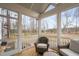 Cozy screened porch featuring comfortable wicker chairs and a small wooden table with views of the outdoors at 280 Scotland Dr, Youngsville, NC 27596