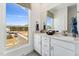 Bathroom featuring a double vanity with white cabinets and a large window with a view at 2906 Kempthorne Rd # 54, Cary, NC 27519