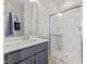 A clean and modern bathroom with a glass-enclosed shower and a vanity with a blue cabinet at 2906 Kempthorne Rd # 54, Cary, NC 27519