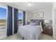 Bright bedroom with two windows, blue curtains, and a comfortable bed with decorative pillows at 2906 Kempthorne Rd # 54, Cary, NC 27519