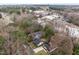 This aerial view shows the property nestled among trees, offering a glimpse of the neighborhood and surrounding landscape at 2908 Woods Pl, Raleigh, NC 27607