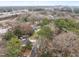 An aerial view of a neighborhood showcasing a variety of homes, mature trees, and surrounding streets at 2908 Woods Pl, Raleigh, NC 27607