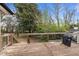 Spacious wooden deck perfect for outdoor dining and entertaining, complete with a grill and overlooking the lush backyard at 2908 Woods Pl, Raleigh, NC 27607