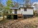 Back exterior of home with a deck featuring stairs leading to the yard at 2908 Woods Pl, Raleigh, NC 27607