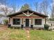 Charming home featuring a covered porch, updated with an appealing exterior and a well-maintained front yard at 2908 Woods Pl, Raleigh, NC 27607