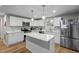 Modern kitchen with stainless steel appliances, marble counters, and central island at 2908 Woods Pl, Raleigh, NC 27607