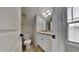 This well-lit bathroom features a vanity with storage, toilet, and natural light at 300 Nelson Ln, Clayton, NC 27527