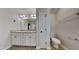 Bright bathroom with double sink vanity, tiled floors, and a separate toilet room for added privacy at 300 Nelson Ln, Clayton, NC 27527